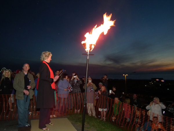 Mrs Lofthouse lights the beacon for the 2012 Diamond Jubilee Celebrations. Photo: Robert Stead